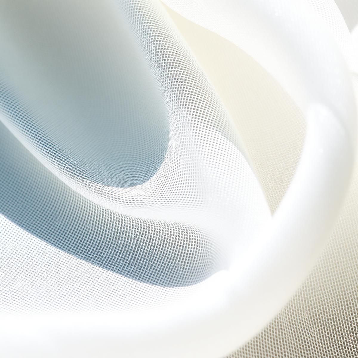 Macro detail of natural fabric woven with fine silver filament